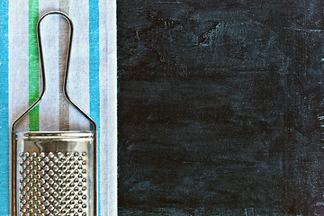 Image showing metal grater and tablecloth 