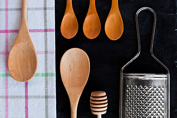 Image showing wooden spoons, metal grater and tablecloth