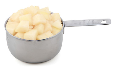 Image showing Diced pear flesh in a cup measure