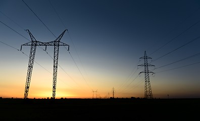 Image showing Large transmission towers at sunset
