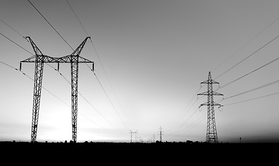 Image showing Large transmission towers at sunset