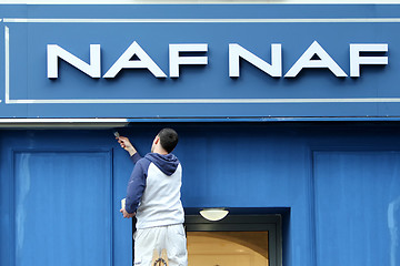 Image showing Worker wall painting NAF NAF store