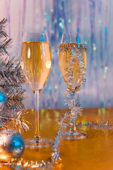 Image showing Glasses with wine, tinsel, Christmas tree and toys