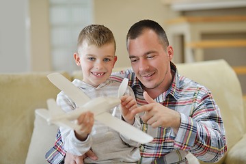 Image showing father and son assembling airplane toy