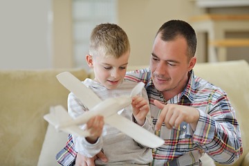 Image showing father and son assembling airplane toy