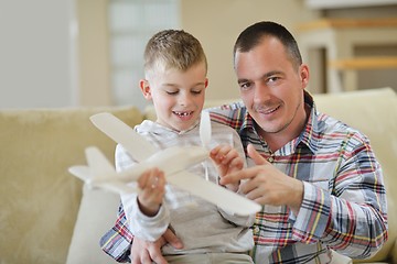 Image showing father and son assembling airplane toy