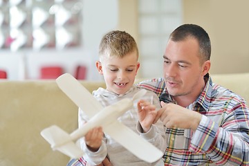 Image showing father and son assembling airplane toy