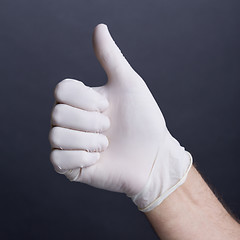 Image showing Male hand in latex glove (thumb up sign)