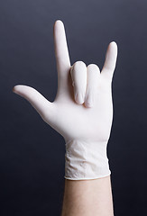 Image showing Male hand in latex glove (love sign)