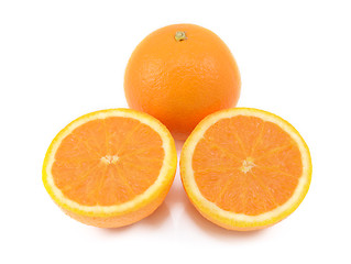 Image showing Whole orange and two juicy cut halves