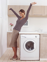 Image showing pretty smiling girl in the laundry room lhk