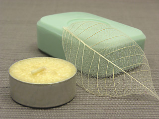 Image showing Green soap with decoration articles on a  gray  background