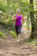 Image showing Pretty young girl runner in the forest. 