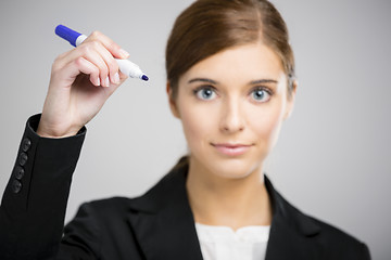 Image showing Businesswoman drawing on a glass board