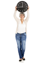 Image showing Elderly woman holding a clock