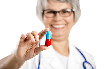 Image showing Female doctor holding  a pill