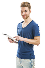 Image showing Young man working with a tablet