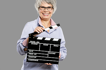 Image showing Elderly woman holding a clapboard