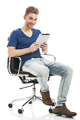 Image showing Young man working with a tablet