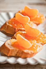 Image showing pieces of baguette with orange marmalade