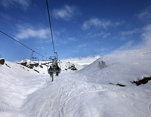 Image showing Chair-lift and off-piste slope in sun day