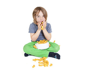 Image showing boy eats peanut chips