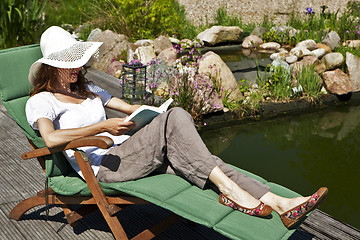 Image showing woman reads at the pond