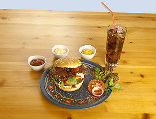 Image showing Hamburger with cola and sauces