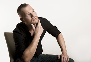 Image showing young man sitting looking up