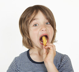 Image showing boy with peanut flips in the mouth