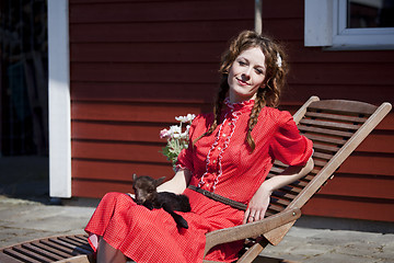 Image showing heidi black lamb is sleeping in her lap