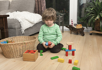 Image showing boy playing with wooden blocks