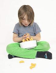 Image showing Boy with bowl full of peanut flips