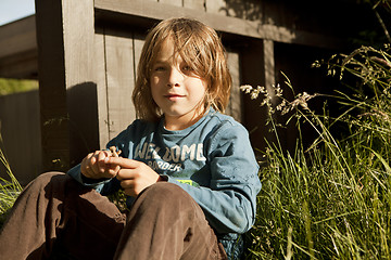 Image showing boy sitting in the garden