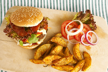 Image showing burger with potato wedges on board
