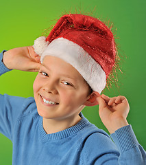 Image showing boy with Santa Claus Hat on green background