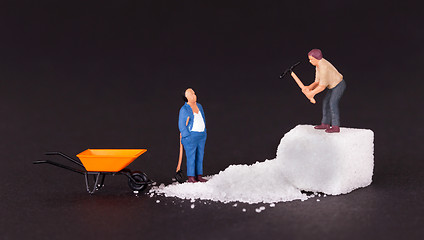 Image showing Miniature worker working on a sugar cube