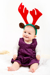 Image showing Child girl with reindeer antlers