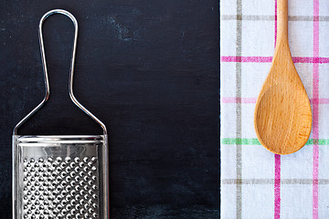 Image showing wooden spoon, metal grater and tablecloth