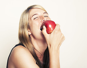 Image showing Woman biting on apple