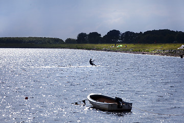 Image showing kitesurfer with motorboat