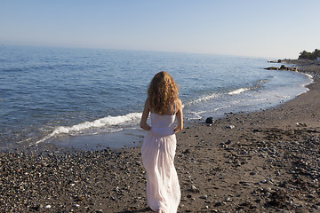 Image showing young woman standing on beach