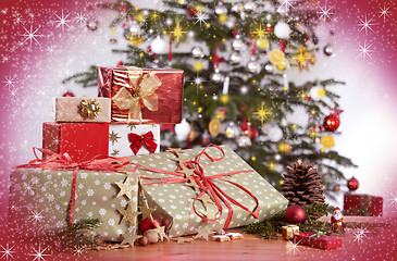 Image showing Gifts and Christmas tree with red glittering background