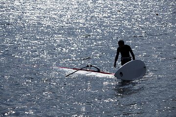 Image showing kitesurfer stands in water