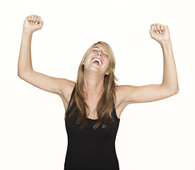 Image showing Woman cheering with arms in the air