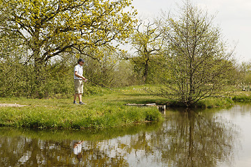 Image showing Fishermen at a fishing pond