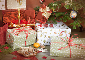 Image showing christmas gifts beside christmas tree