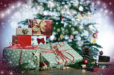 Image showing Christmas gifts in front of Christmas tree and stars