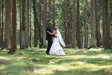 Image showing Bride and groom dancing in the forest