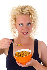 Image showing Young woman showing cornflakes